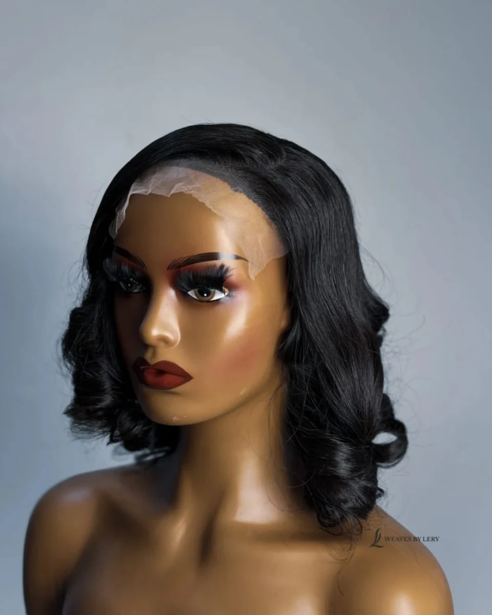 Oreke side-swept short black curls on a mannequin, original product photograph
